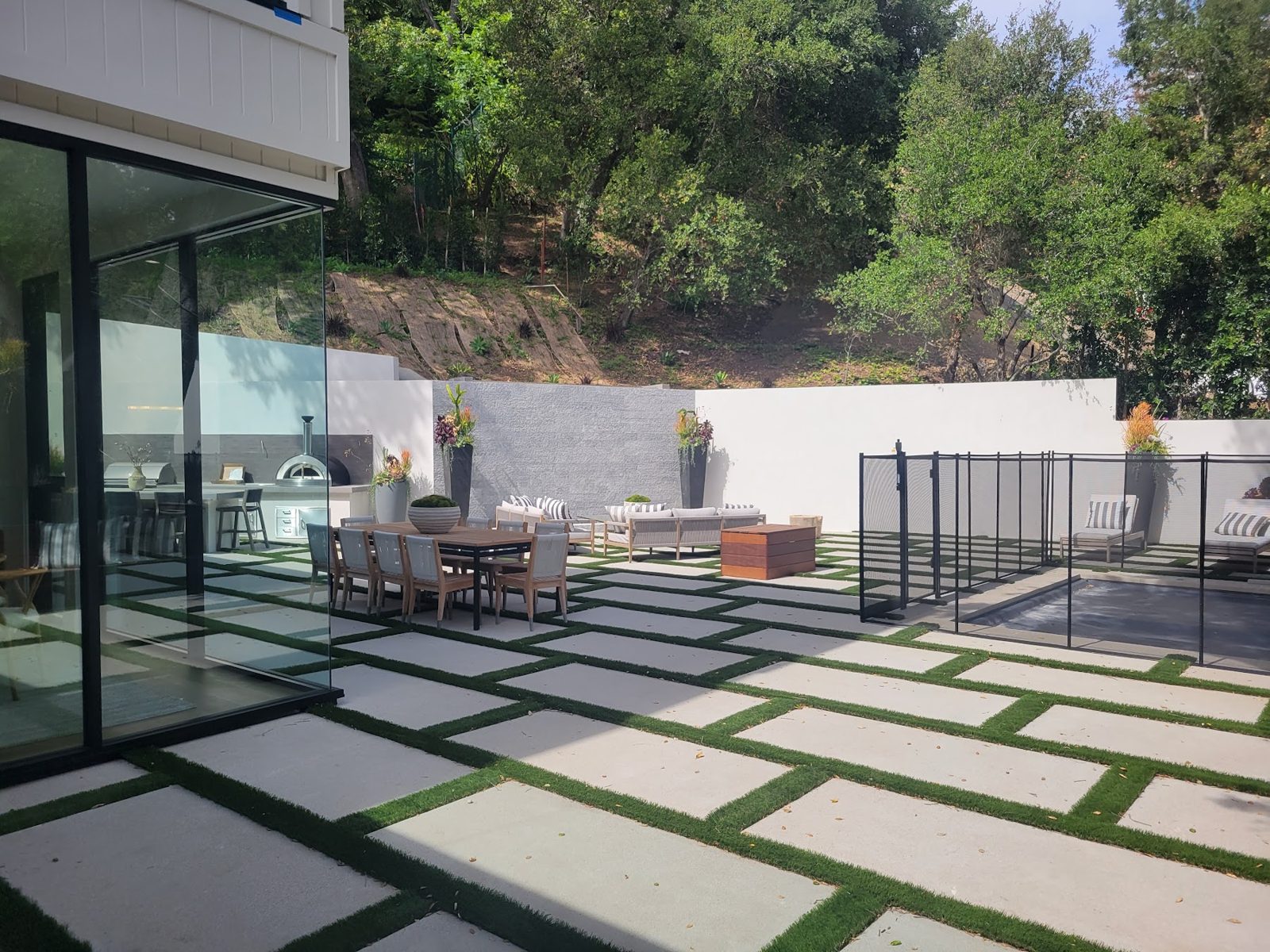 Modern Brentwood custom home with a pool terrace and full-height glass walls
