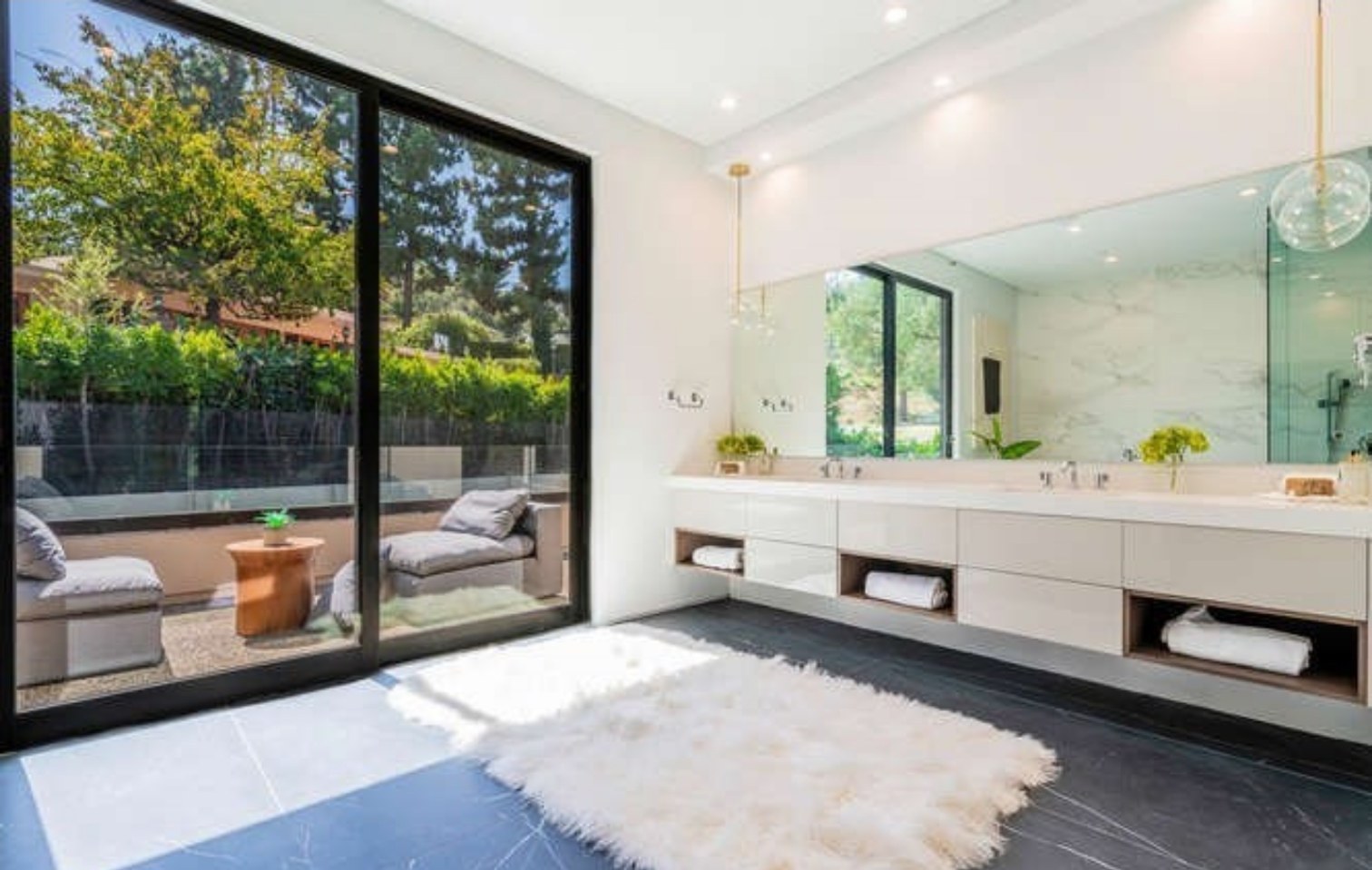 Primary bathroom with floating vanity and glass shower