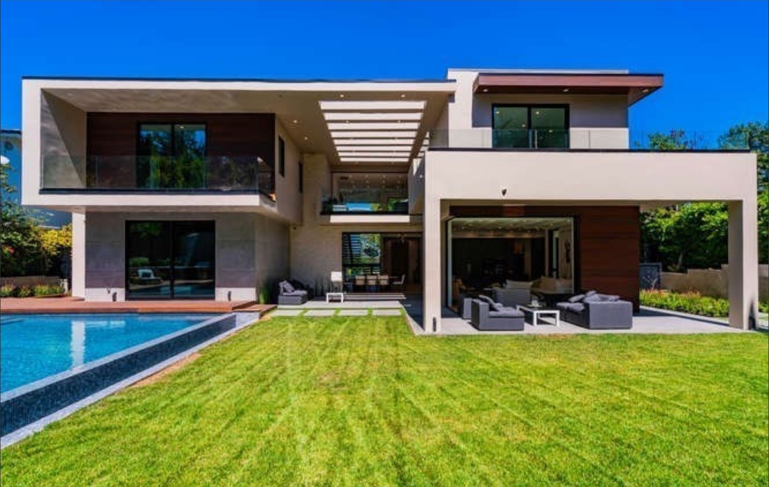 Rear elevation and lawn with covered outdoor living area