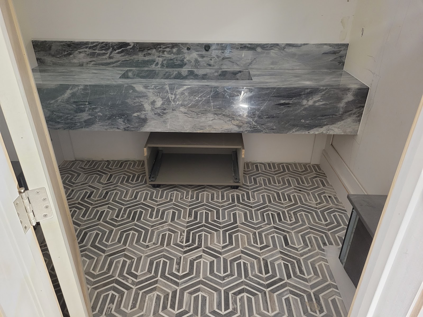 Stone fireplace surround with patterned tile floor — Boca de Canon custom home build in Brentwood, Los Angeles