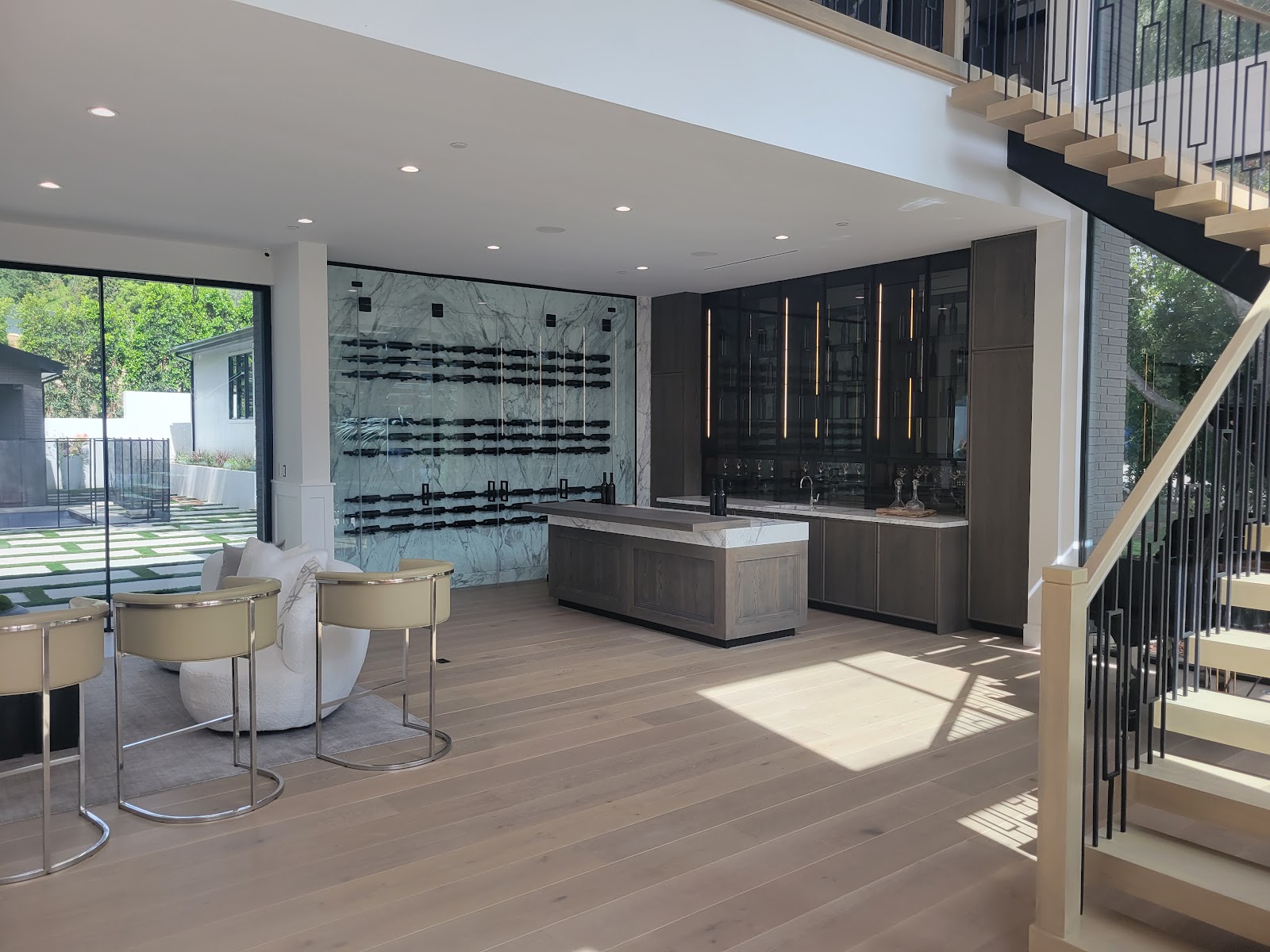 Dining area beside the glass wall to the courtyard — Boca de Canon custom home build in Brentwood, Los Angeles