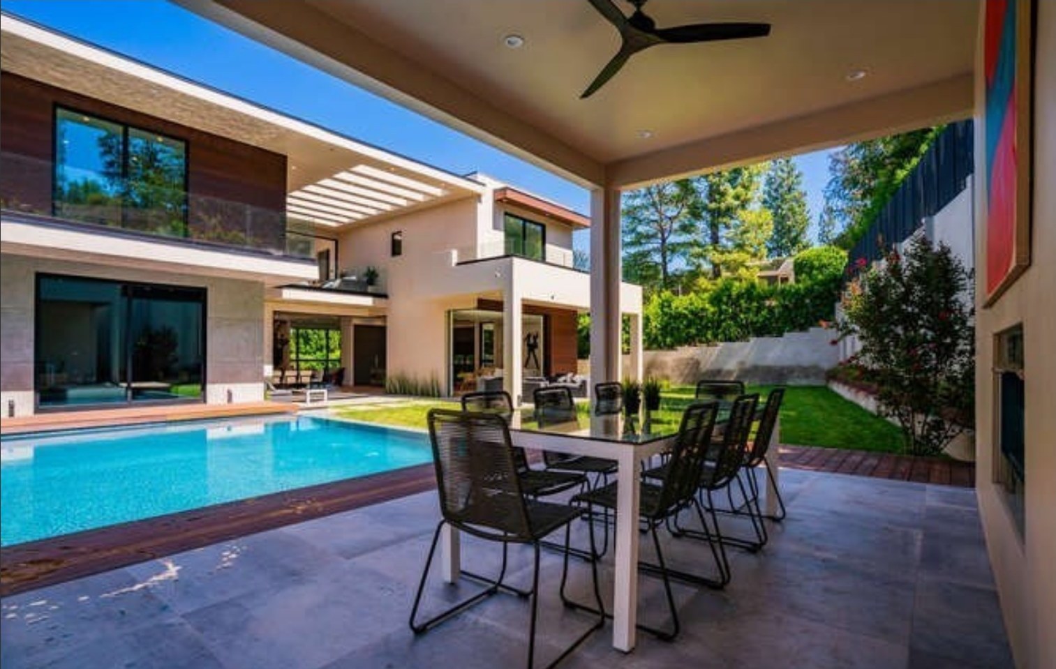 Covered patio and dining area beside the pool