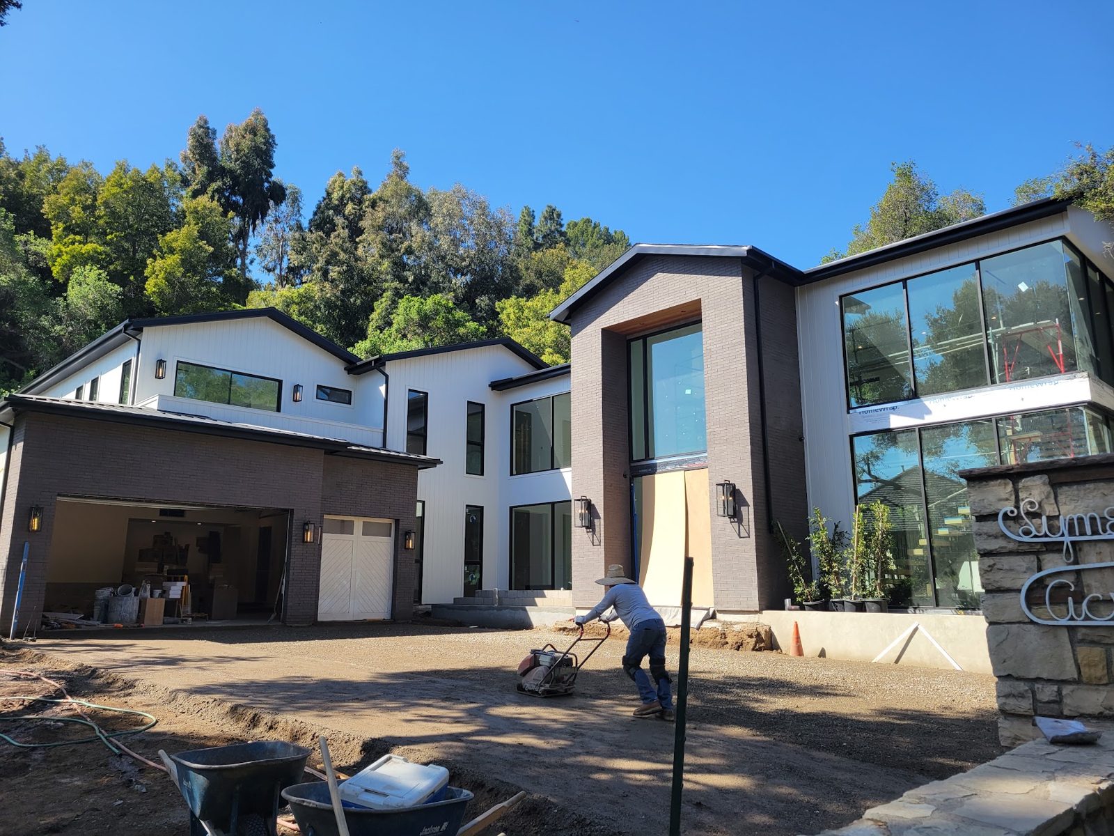 Exterior nearing completion with scaffolding — Boca de Canon custom home build in Brentwood, Los Angeles