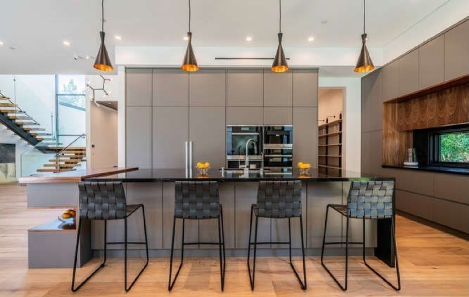 Kitchen island with bar seating and full-height cabinetry
