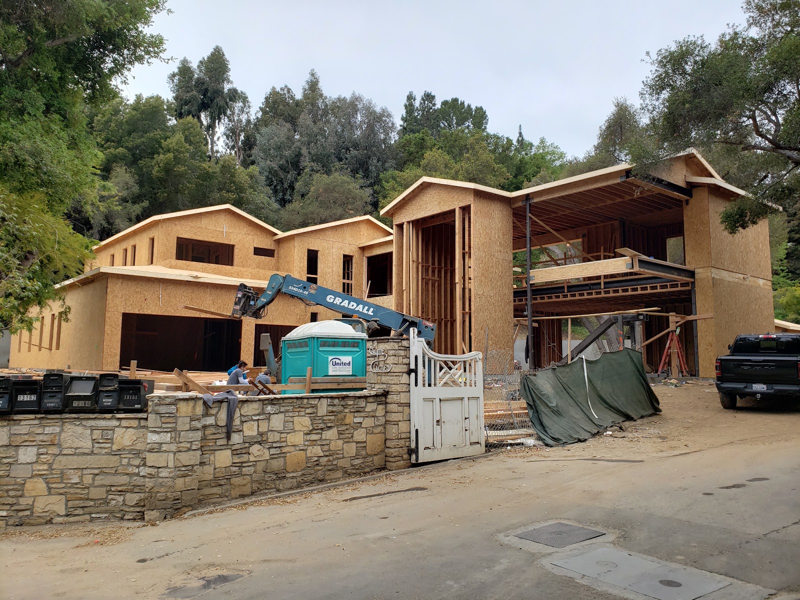 Exterior framing and roof structure from the street — Boca de Canon custom home build in Brentwood, Los Angeles