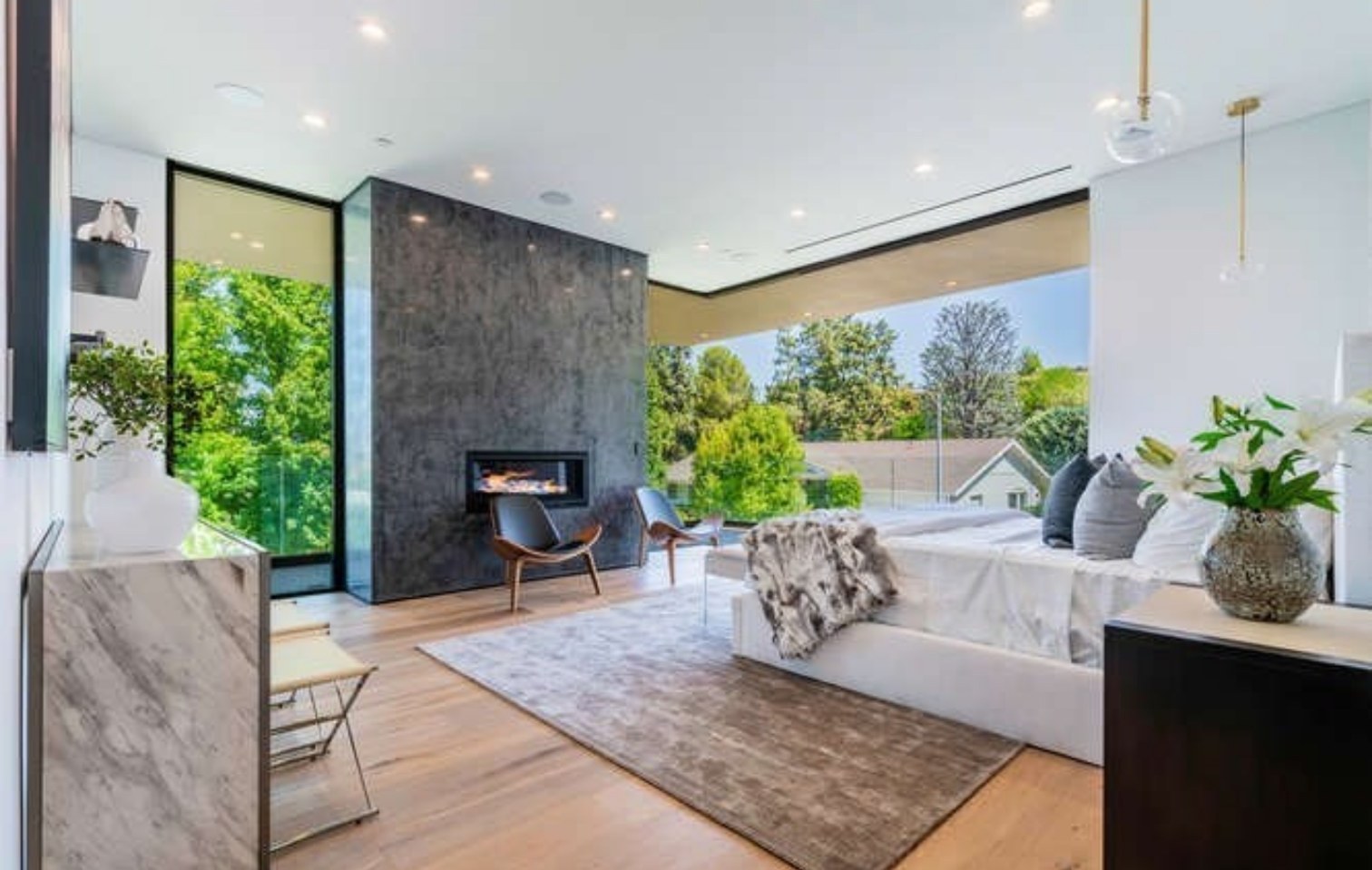 Primary bedroom with stone fireplace wall