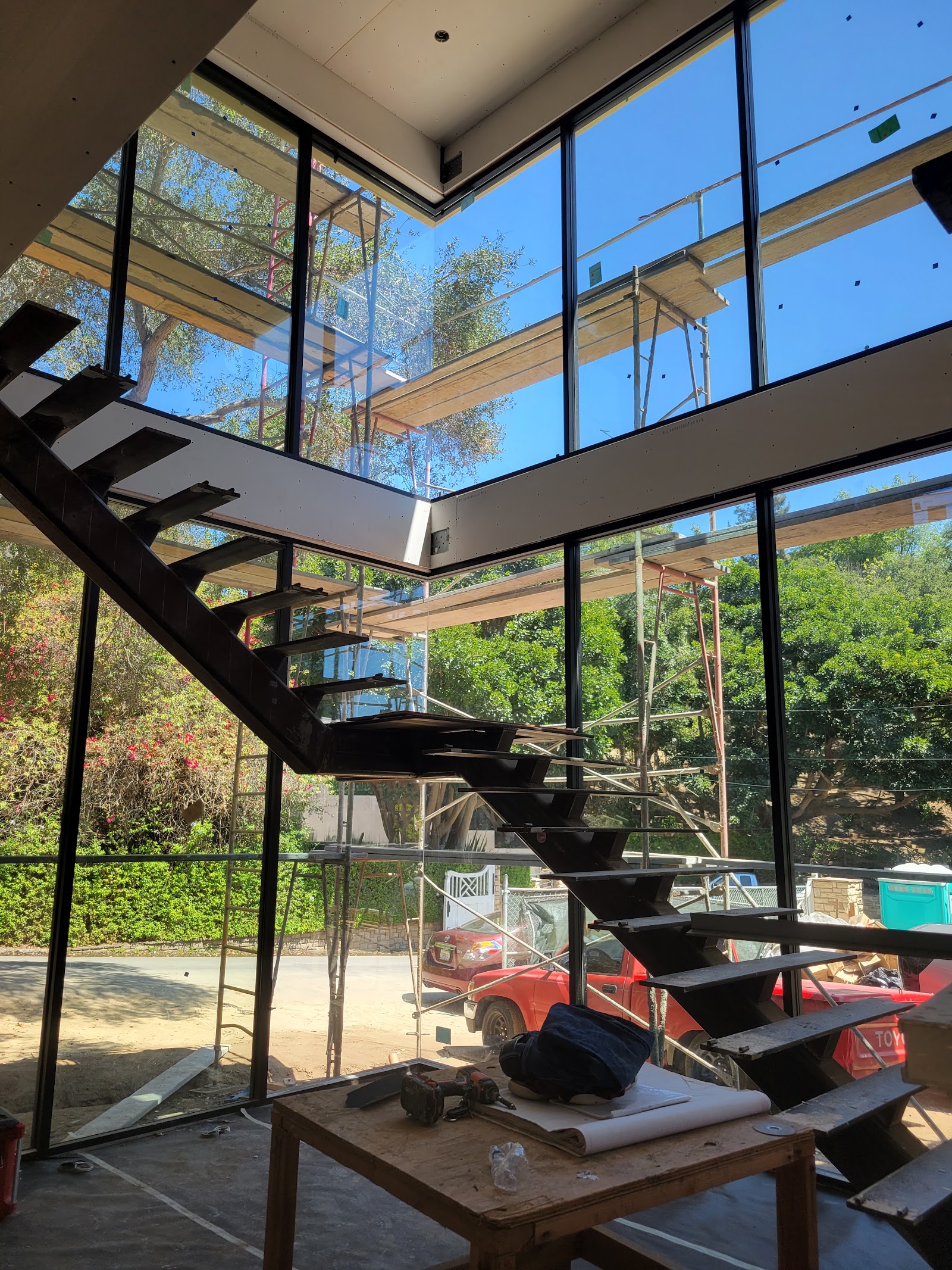 Open stair with glass guardrail beside the pool window — Boca de Canon custom home build in Brentwood, Los Angeles