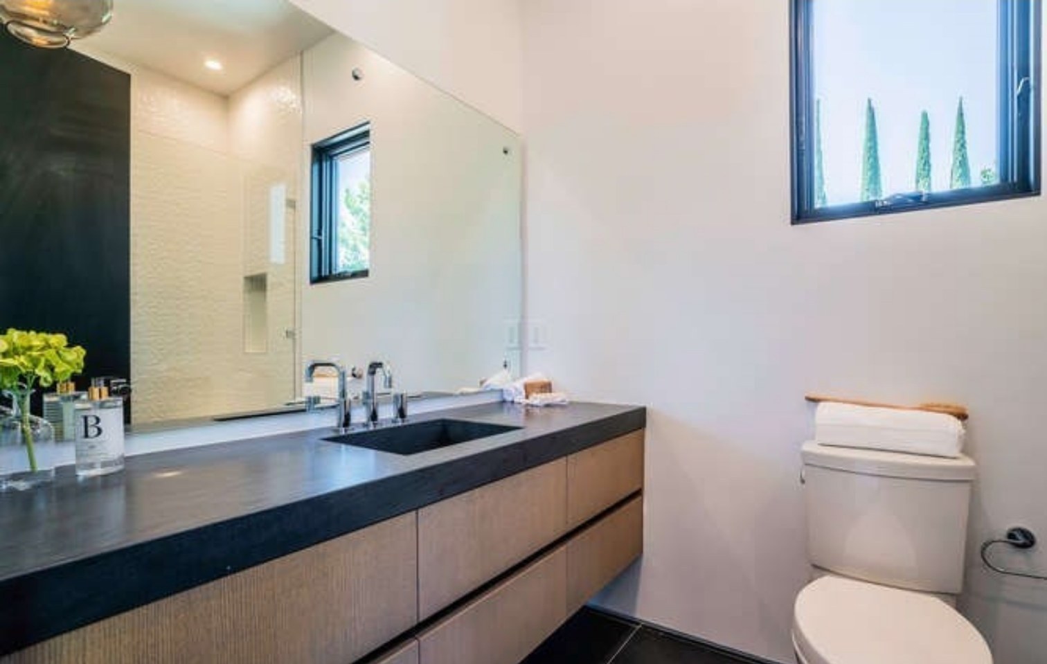 Floating stone vanity in a guest bathroom