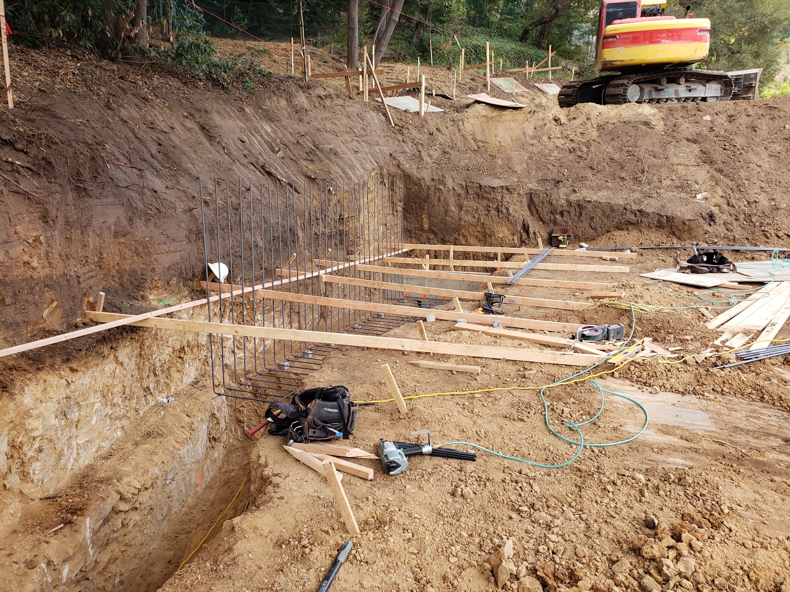 Excavation for footings on the hillside lot — Boca de Canon custom home build in Brentwood, Los Angeles