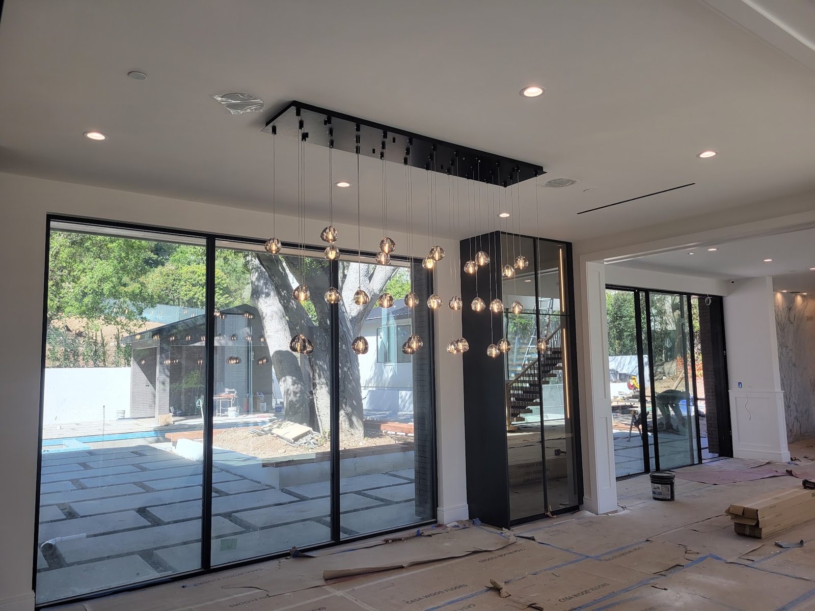 Kitchen with sliding glass doors to the courtyard — Boca de Canon custom home build in Brentwood, Los Angeles